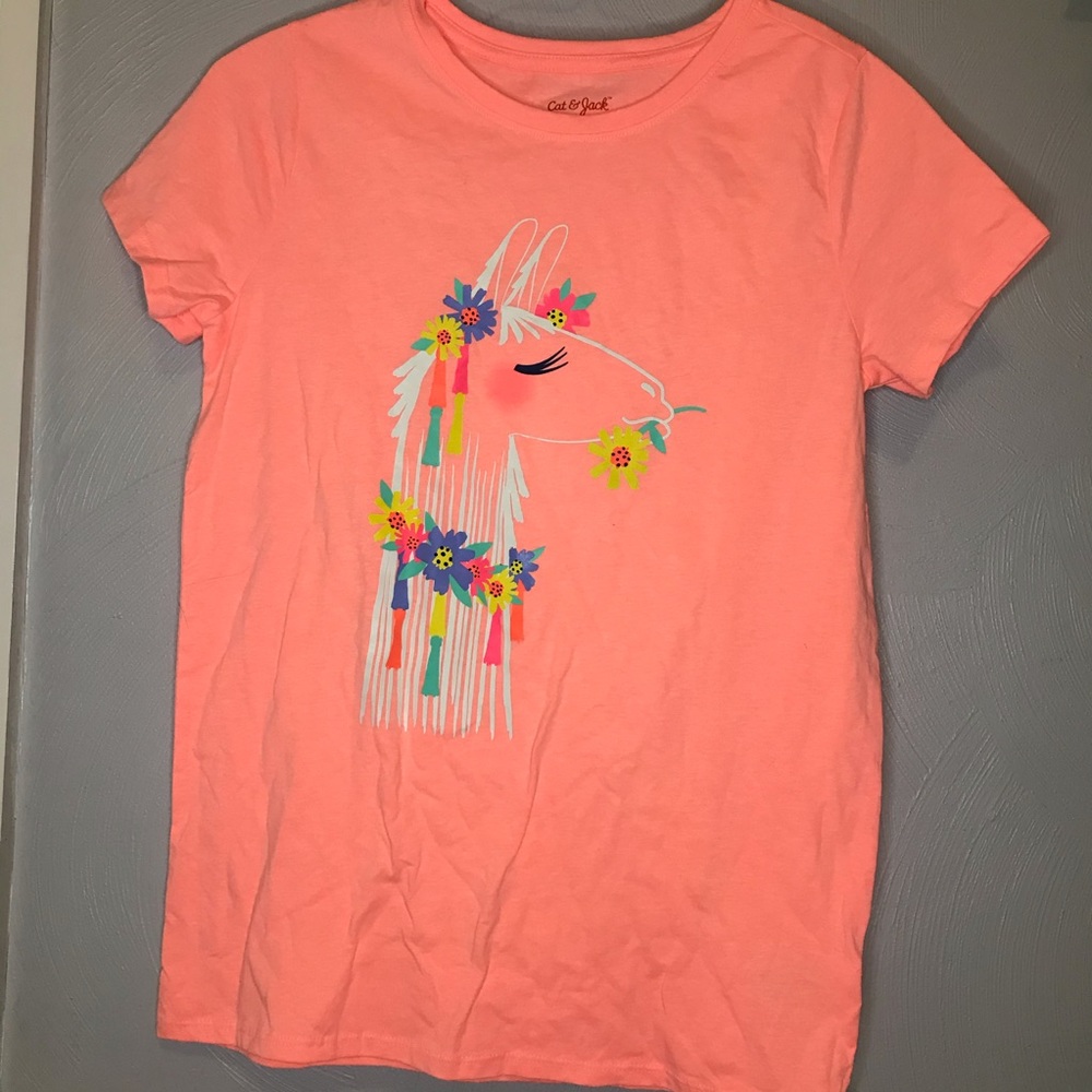 coral colored T-shirt with a llama holding flowers